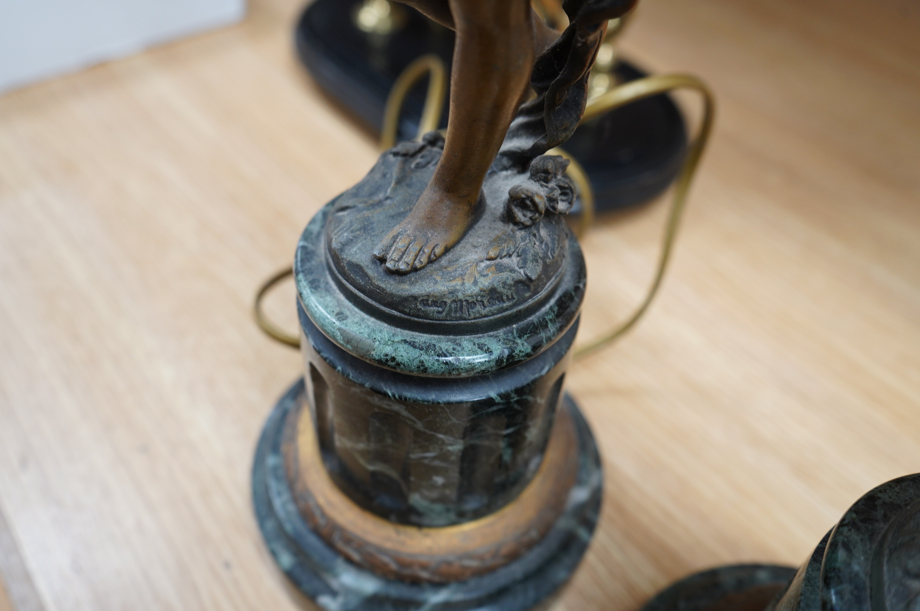 A pair of bronzed spelter ‘putto’ lamps, serpentine marble bases, 60cm. Condition - fair to good, not tested